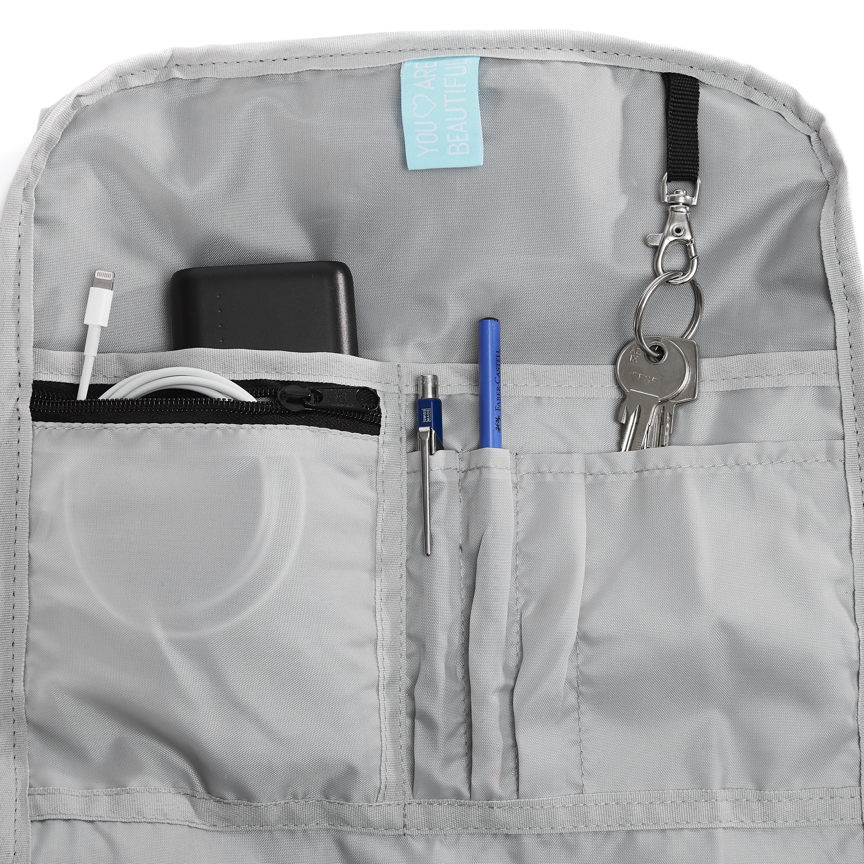 Ela Mo™ Rolltop Rucksack | Bloom! Innenbereich des Rucksacks mit kleinen Fächern und Schlüsselanhänger.